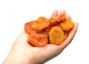 dried apricots in a hand on a white background