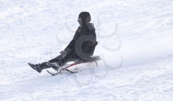man sledding in the snow