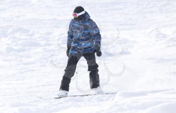people snowboarding on the snow in the winter