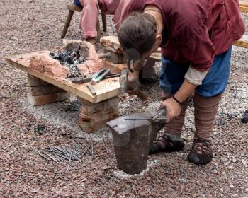 blacksmith forges metal