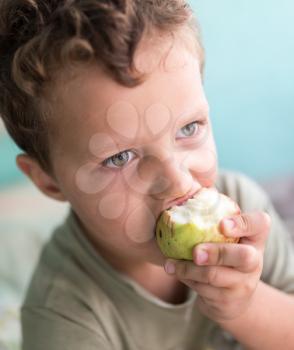 boy eats an apple