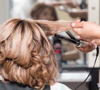 Female Hairstyles on curling in a beauty salon