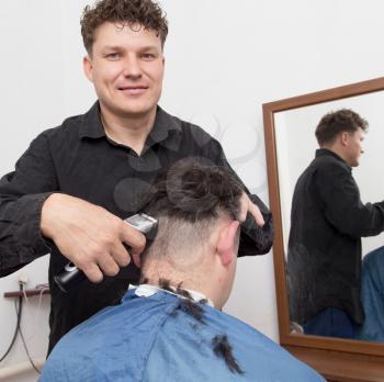 hairdresser cuts men's hair cut