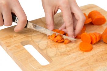 cook cuts carrots on a white background