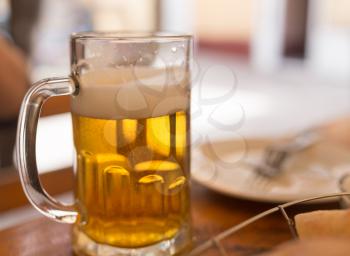 Beer mug on the table in a cafe .
