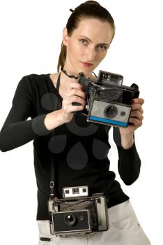 Beautiful girl with two vintage cameras, isolation on white