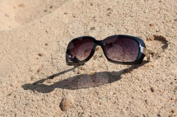 Royalty Free Photo of a Pair of Sunglasses in the Sand