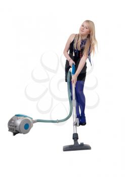 Royalty Free Photo of a Girl Using a Vacuum Cleaner