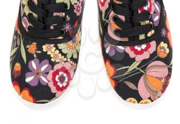 black sneakers with floral pattern isolated on a white background