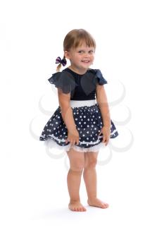 Little girl in a polka dot dress in studio isolated on white background.