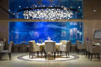 Interior of a modern restaurant with aquarium.
