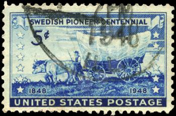 Royalty Free Photo of 1948 US Stamp Shows a Pioneer With Covered Wagon Moving Westward, Swedish Pioneer Issue