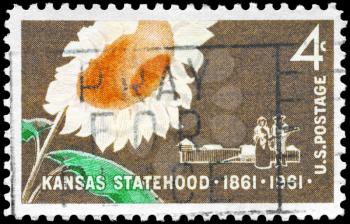 Royalty Free Photo of 1961 US Stamp Shows the Sunflower, Pioneer Couple and Stockade, Kansas Statehood Centenary