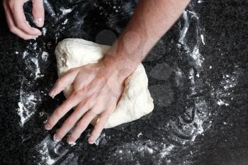 Royalty Free Photo of a Person Kneading Dough