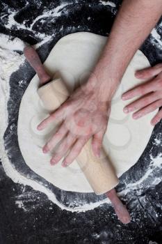 Royalty Free Photo of a Person Rolling Out Dough