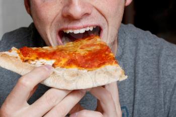 Royalty Free Photo of a Man Eating Pizza