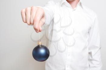 Royalty Free Photo of a Man Holding a Christmas Ornament