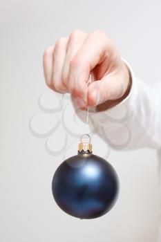 Royalty Free Photo of a Man Holding a Christmas Ornament