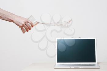 Royalty Free Photo of a Person Spilling Water on a Computer