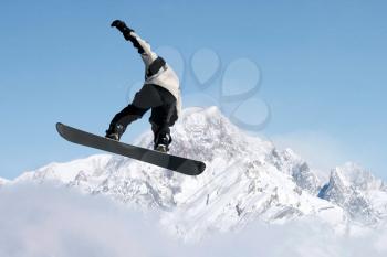 Royalty Free Photo of a Man Snowboarding