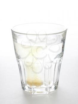 Royalty Free Photo of a Tablet in a Glass of Water