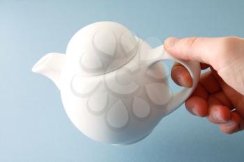 Royalty Free Photo of a Person Holding a Teapot