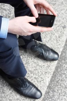Royalty Free Photo of a Businessman Texting on a Cellphone