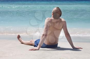 Royalty Free Photo of a Man Sitting on th Beach