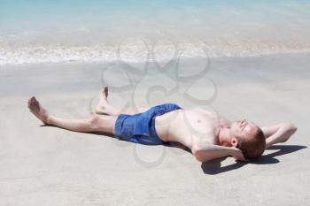 Royalty Free Photo of a Man Relaxing on the Beach