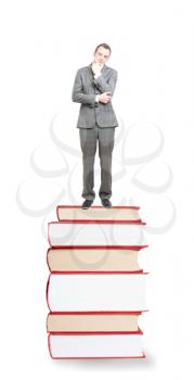 Royalty Free Photo of a Businessman Standing on a Pile of Books
