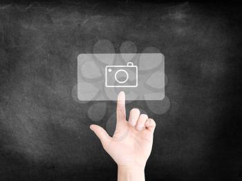 Finger tapping on an icon to symbolize digital photography