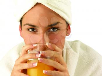 Royalty Free Photo of a Woman With Her Head Wrapped in a Towel Enjoying a Glass of Juice