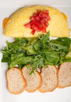 Royalty Free Photo of an Omelet with Salad and Bread