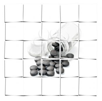 brown pills spilled from glass bottle on white background