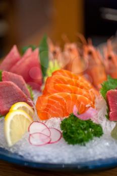 Japanese style assorted sashimi dish laid over crushed ice
