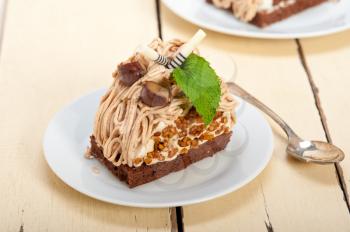 fresh baked chestnut cream cake dessert over rustic white wood table 