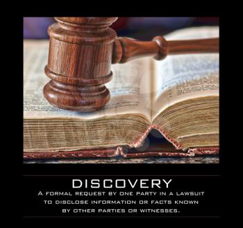 Royalty Free Photo of a Gavel and Book With a Definition of Discovery