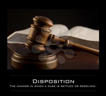 Royalty Free Photo of a Gavel and Book With the Definition of Disposition