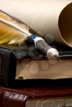Royalty Free Photo of a Feather Pen, Books and Paper