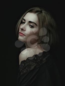 Dramatic female portrait against dark backgrounds