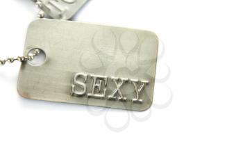 Royalty Free Photo of the Word Sexy on a Metal Tag