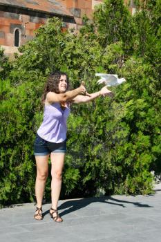 Royalty Free Photo of a Woman Releasing a Bird
