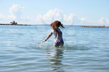 Royalty Free Photo of a Woman Walking in the Sea