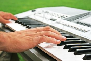 Royalty Free Photo of a Musician Playing the Piano