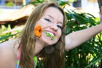Royalty Free Photo of a Woman Biting a Flower