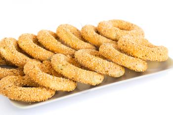 Round rusks with sesame seeads on tray.
