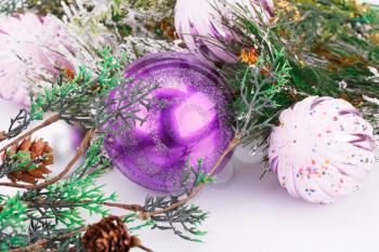 Christmas pink balls and fir tree on gray background.