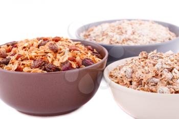 Muesli in the bowls on white background.