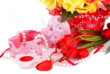 Colorful flowers, candle, beads and gift box close up picture.