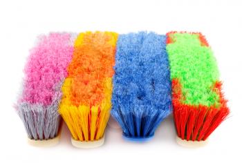 Colorful brooms isolated on white background.